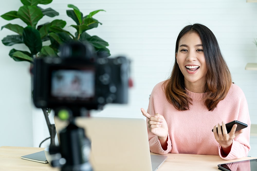 Female Influencer Recording a Video for Facebook