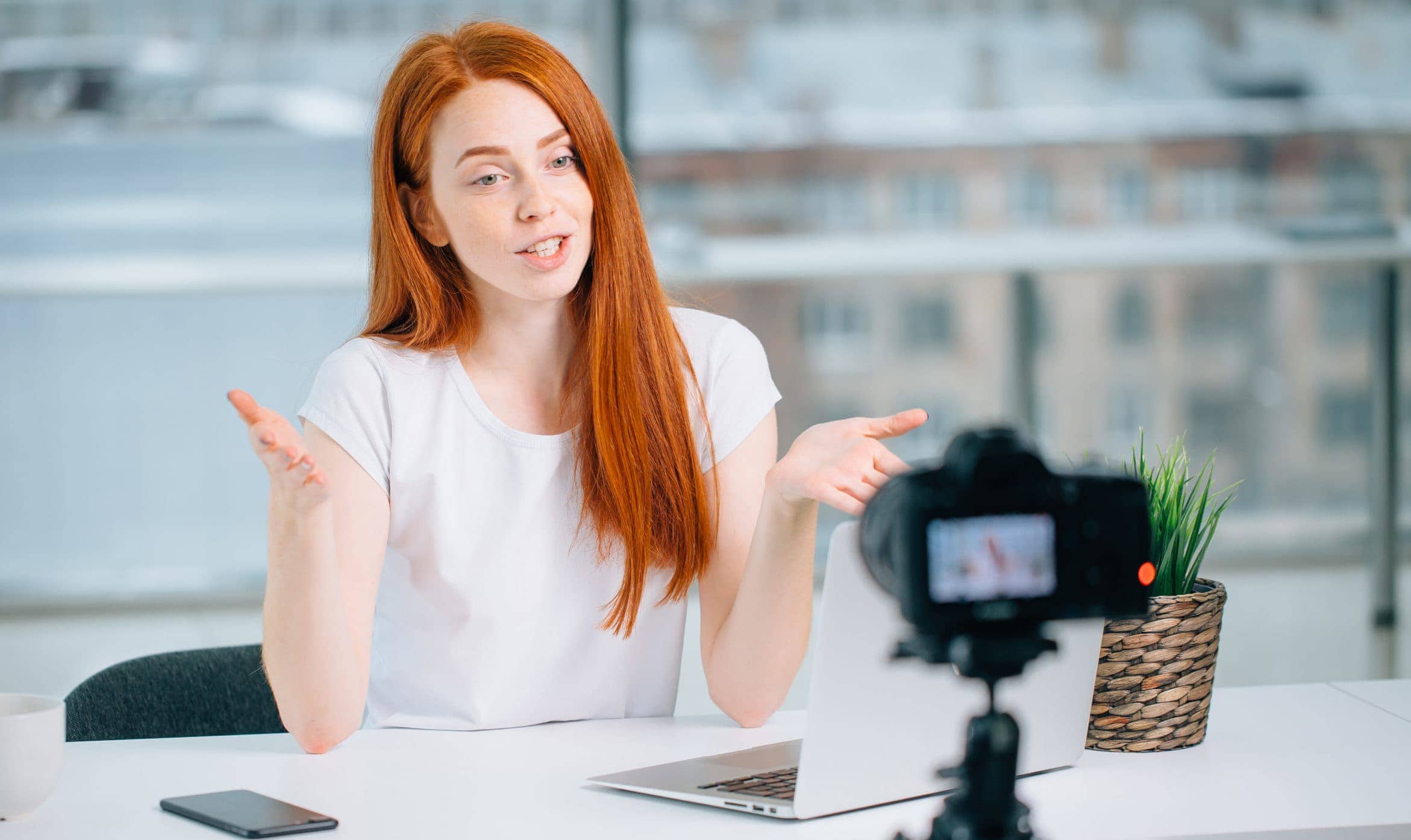 woman sitting in front of camera recording video