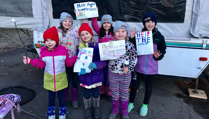 children holding signs to support spectrum