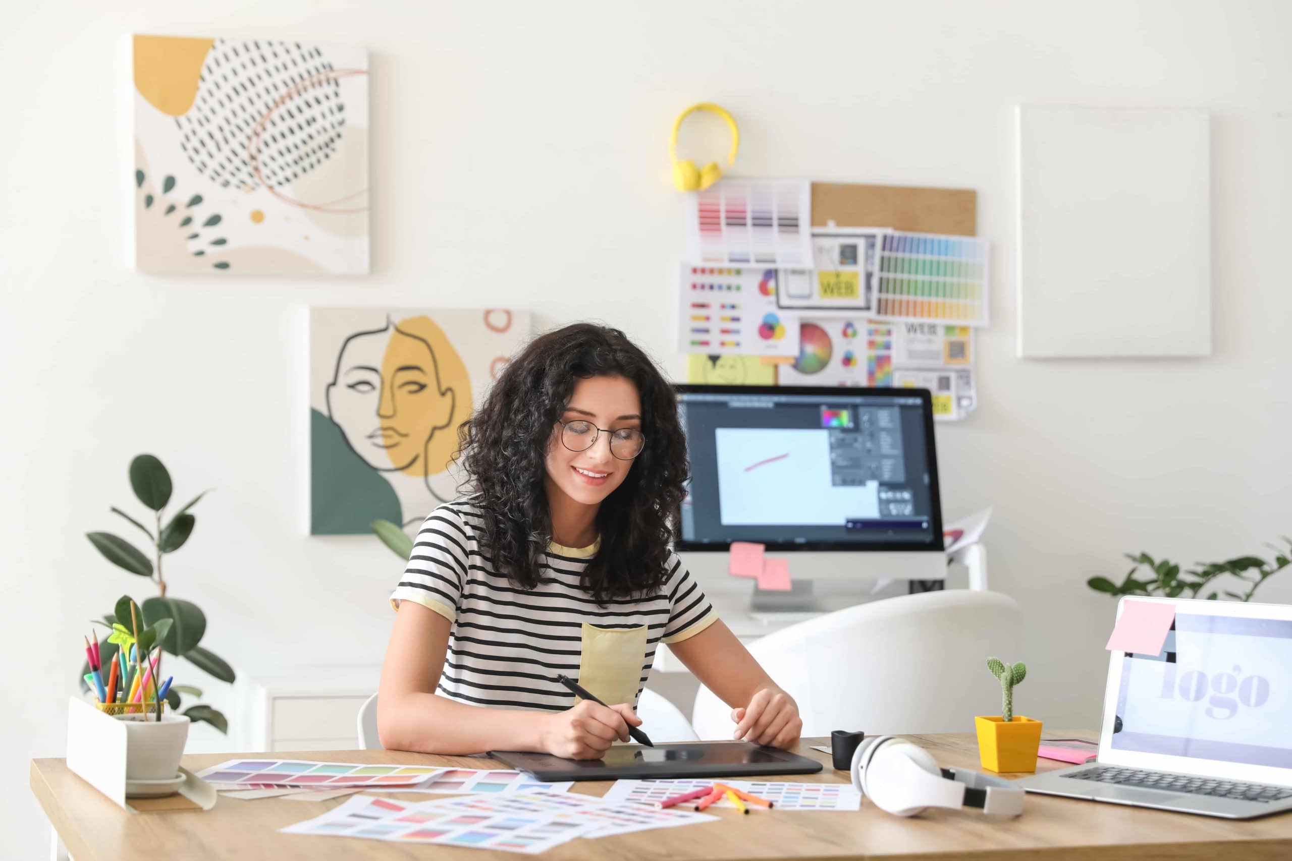 woman at desk using graphic design tools