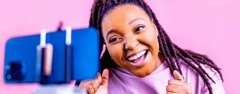 woman wearing pink talking to a phone on a tripod is tiktok for real estate worth it