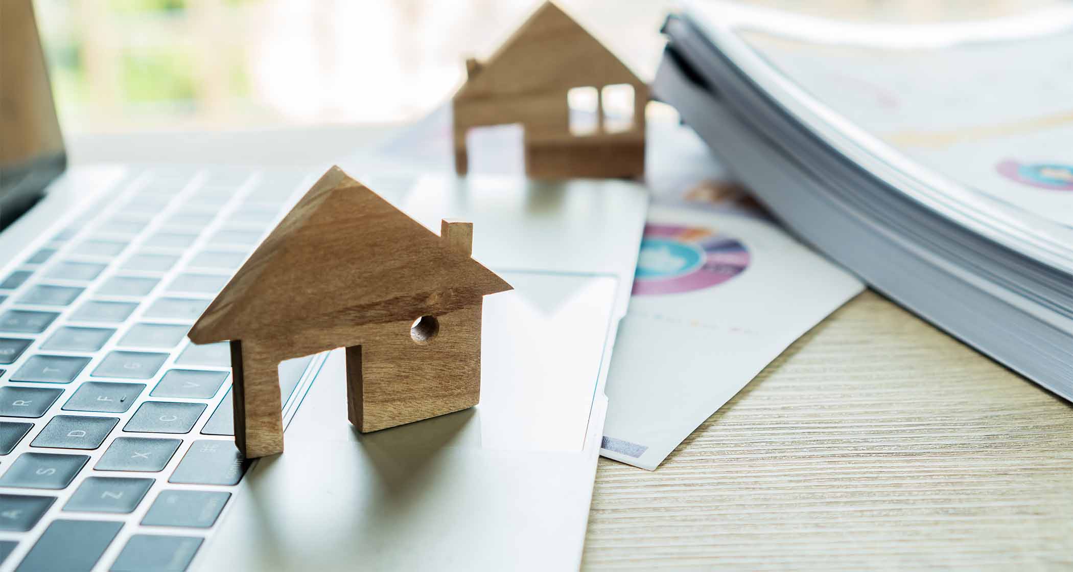 2 wooden houses on a laptop