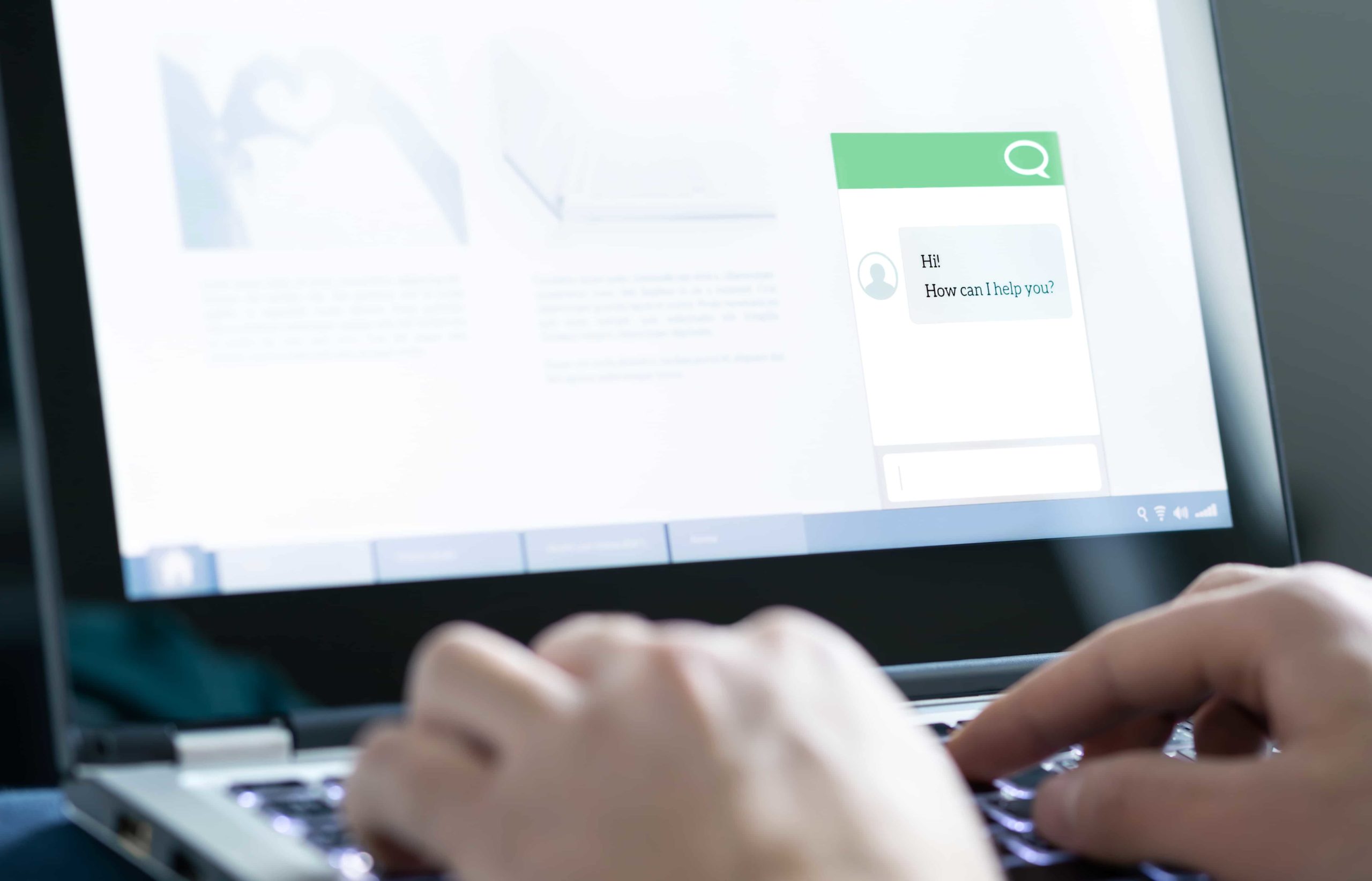 person typing on a computer and engaging with a chatbot